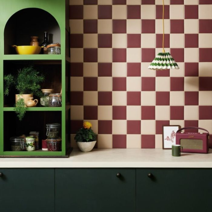 A distinctive kitchen design featuring a unique green and red checkered wall