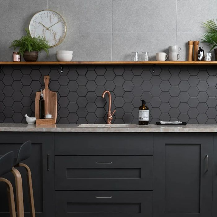 Modern kitchen design featuring black tile backsplash