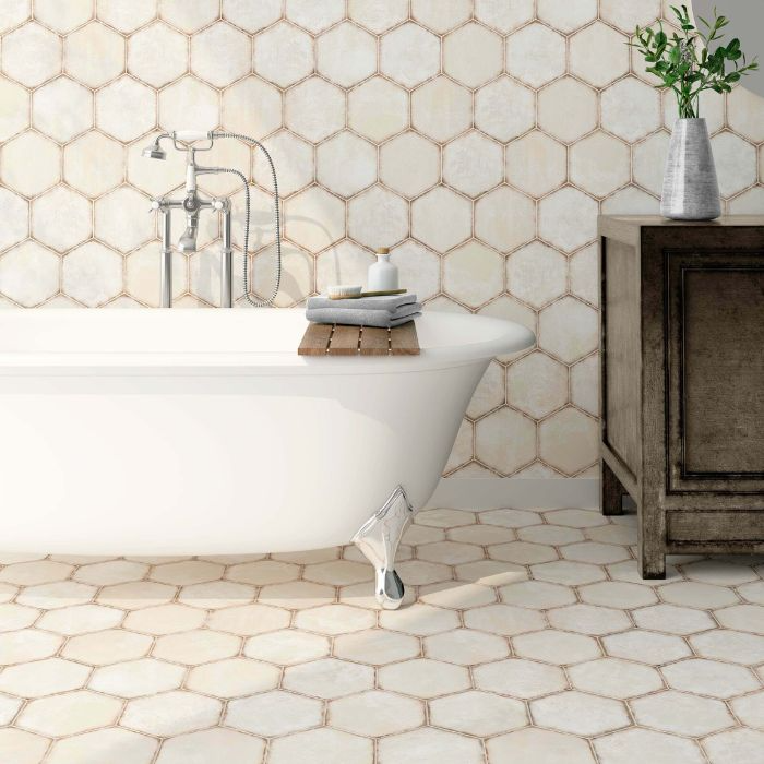 Spacious bathroom with hexagon tiles and a white tub