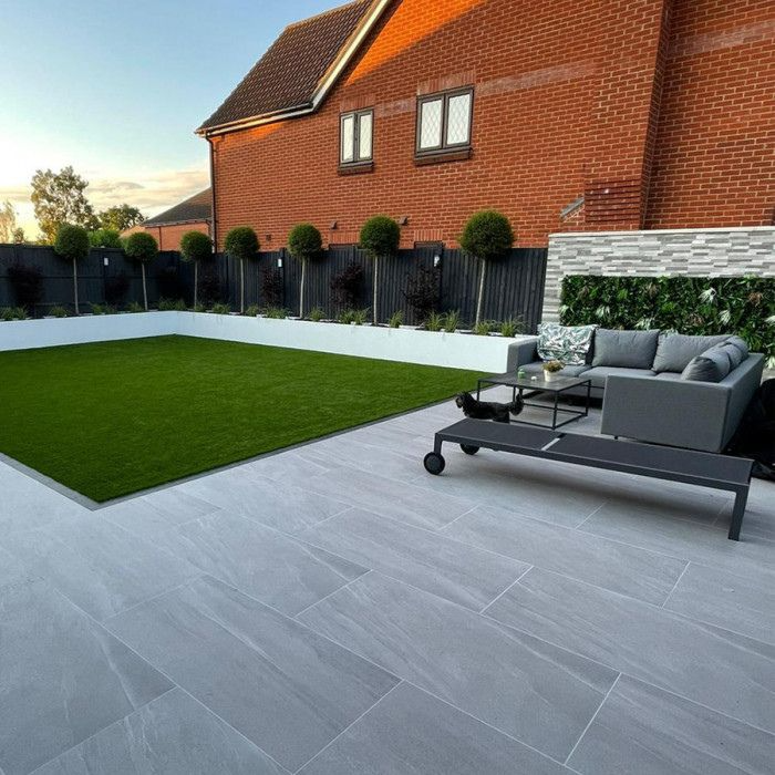 Outdoor relaxation area with a pristine grey tiled patio