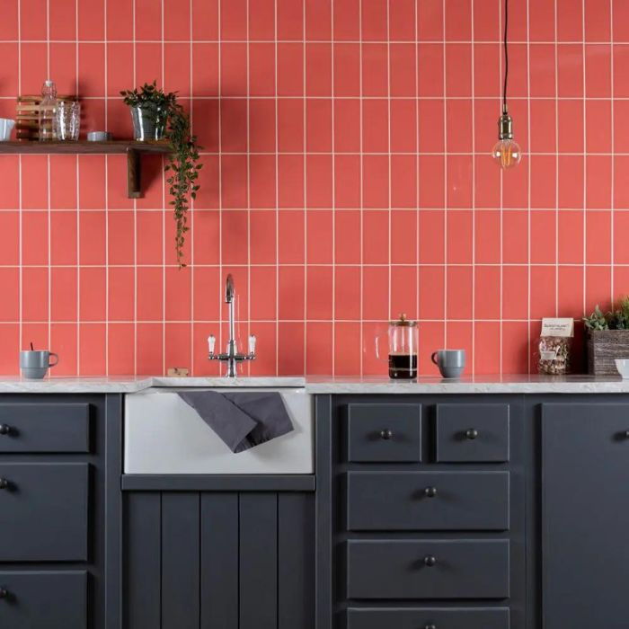 Kitchen with vibrant red subway tiled wall