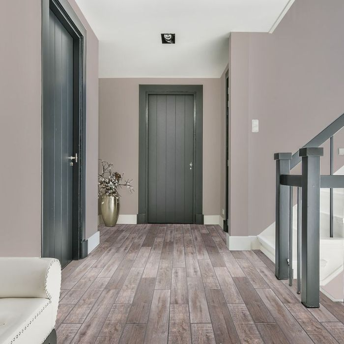 Elegant hallway featuring polished wood floors and a charming staircase