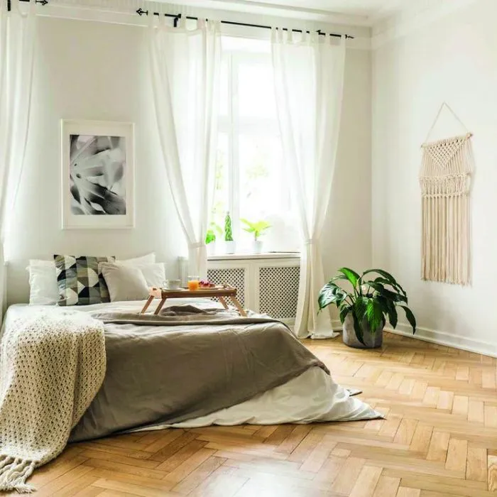 Tranquil bedroom featuring bamboo flooring and soft white walls