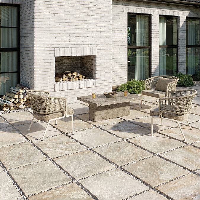 Outdoor seating area set against a backdrop of beige stone-effect outdoor tiles