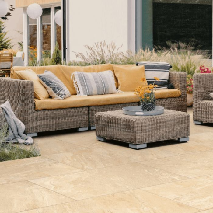 Beige and wicker patio furniture on warm outdoor tiles