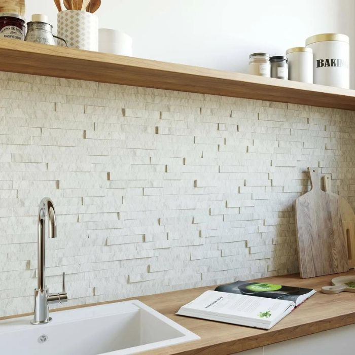 Modern white kitchen interior with wooden touch and textured backsplash