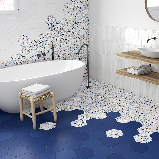 Hexagon tiles in shades of blue and white create a soothing atmosphere in a bathroom with a bathtub