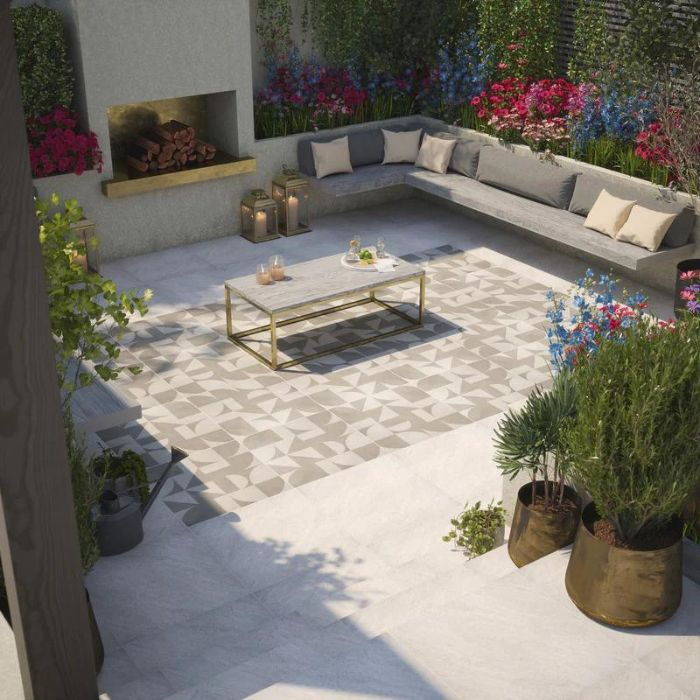 Al fresco relaxation spot with a trendy fire pit and colourful blooms on sleek outdoor tiles