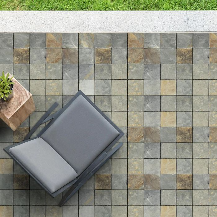 Relaxing outdoor space furnished with a table and chair on stone-effect decking tiles