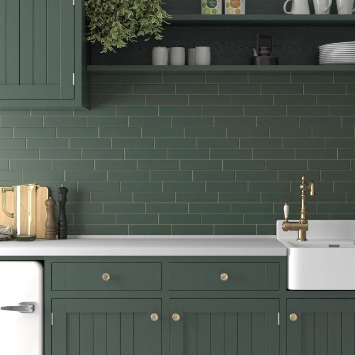 Vibrant green kitchen with white cabinets and sink