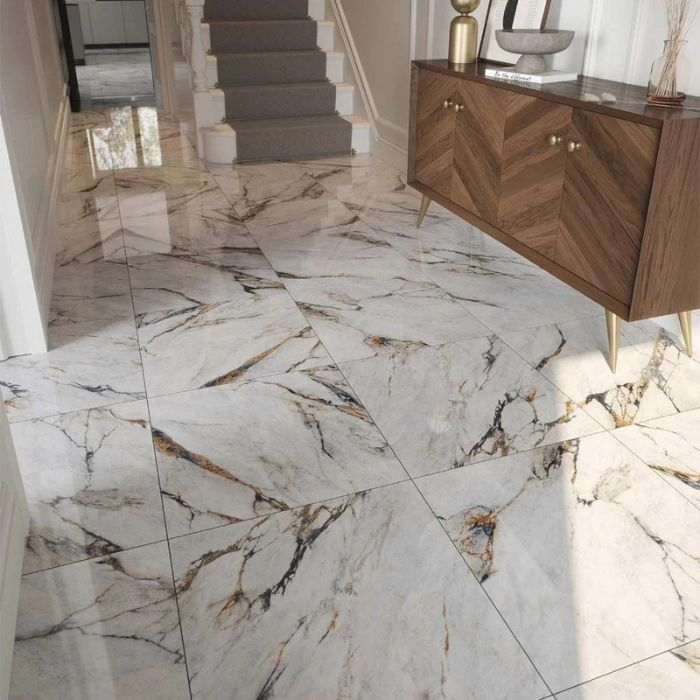 A gleaming white marble floor stretches down a stylish hallway, reflecting soft light