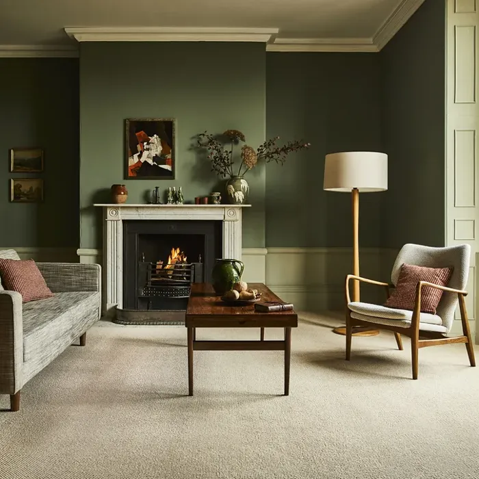 A cosy lounge featuring vibrant green walls and a warm fireplace, complemented by elegant flooring