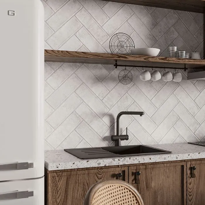 A bright and airy kitchen space featuring wooden cabinets and a refrigerator