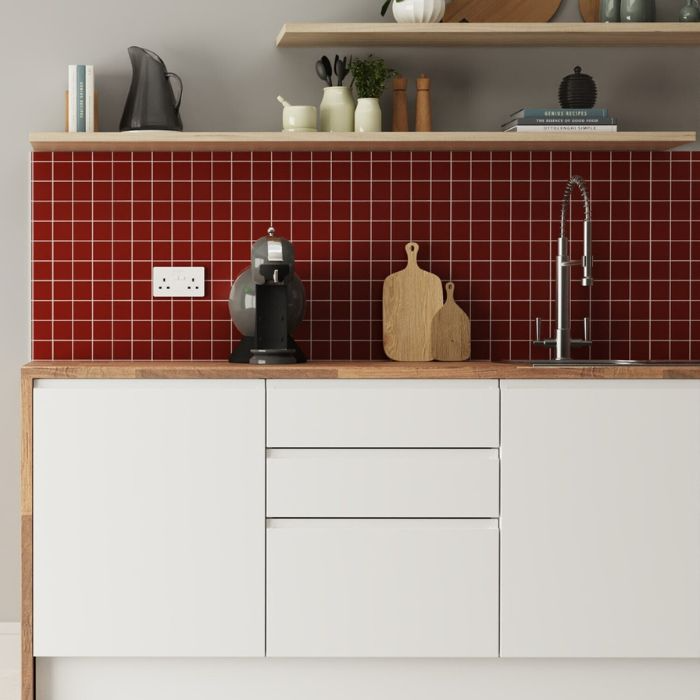 Modern kitchen design featuring bold red tiles and clean white cabinets