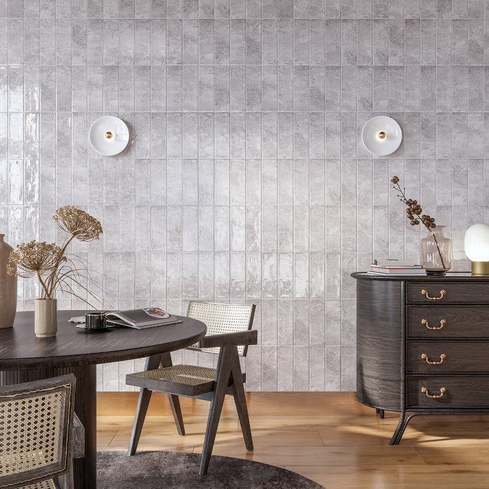 Modern dining room with grey metro tiled wall and wooden table