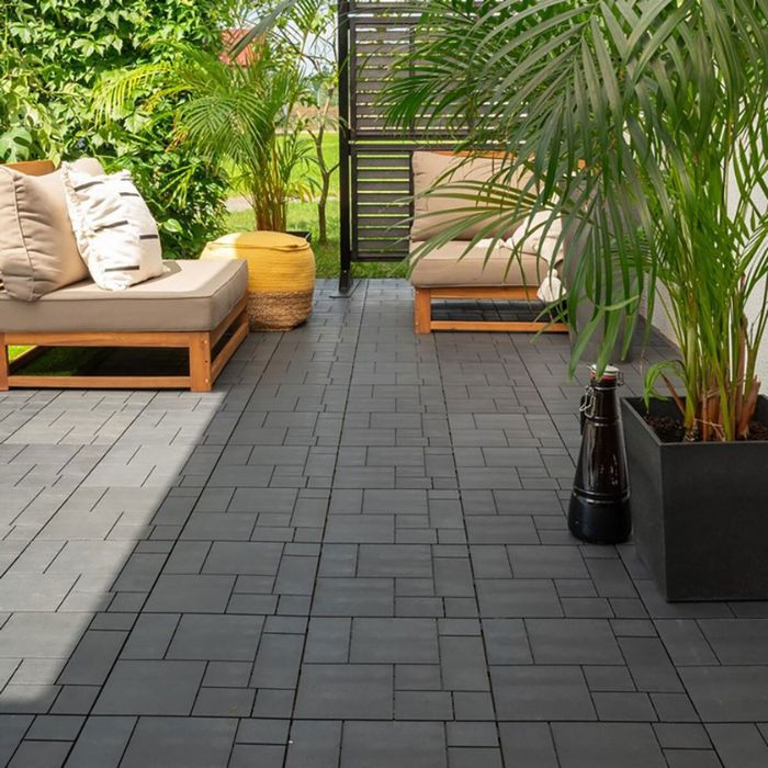 Chic patio design featuring black tiles and potted plants