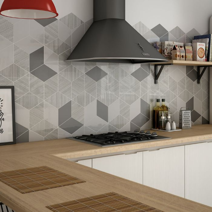 Wooden counter and intricate tiled backsplash in a modern kitchen