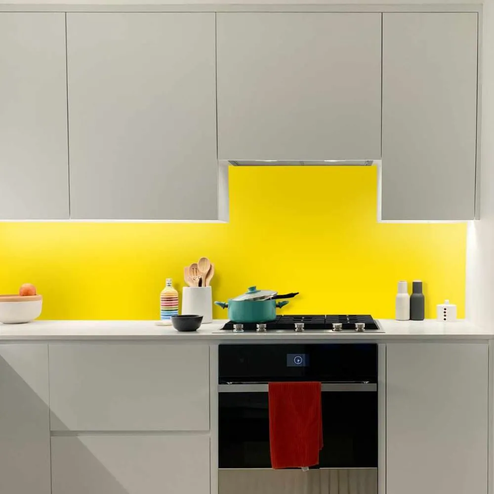 Bright kitchen with sunny yellow splashback and sleek white cabinets