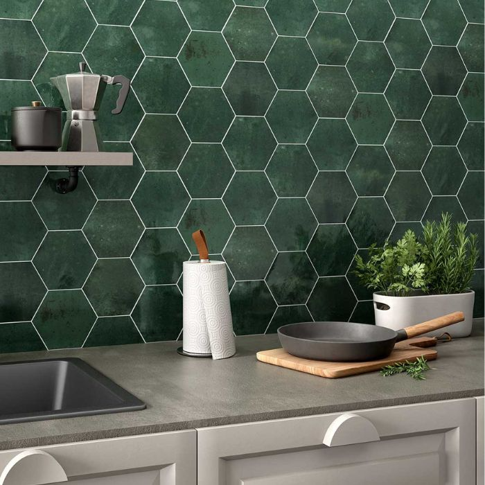 Green tiled kitchen wall with modern appliances