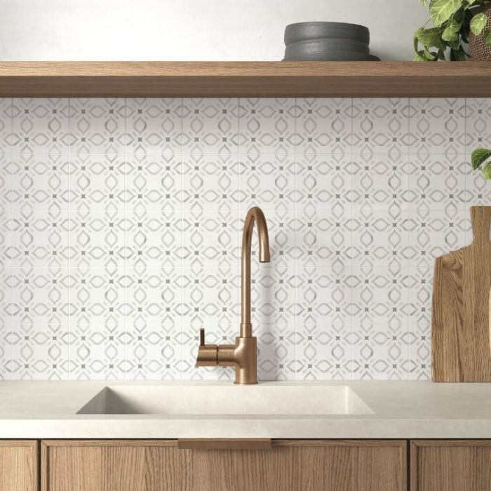 Stylish white patterned tiles complementing warm wooden cabinets and a rustic wooden sink