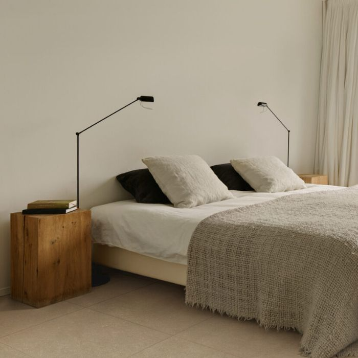 Stylish bedroom with modern tiled flooring, featuring a neatly made bed