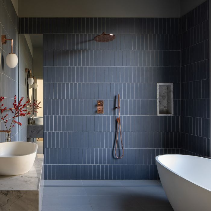 Bathroom interior featuring striking blue tile pattern