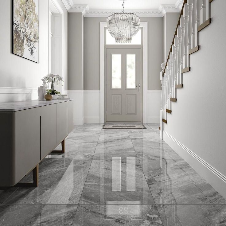 Stunning marble flooring leads through a hallway, highlighted by an exquisite chandelier