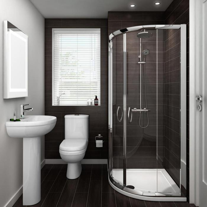 Compact ensuite featuring dark tiles