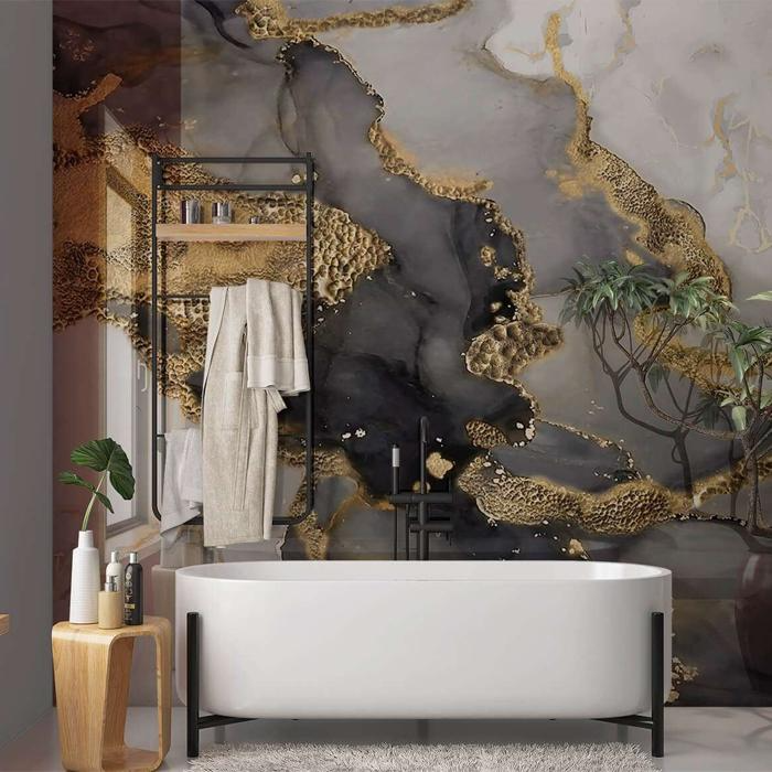 Abstract marble panelling behind a freestanding bathtub