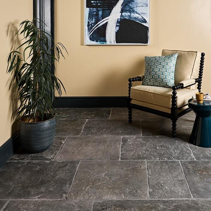 Armchair with blue cushion on grey sandstone tiles