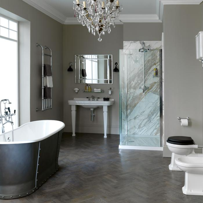 Herringbone pattern dark grey floor tiles in elegant bathroom