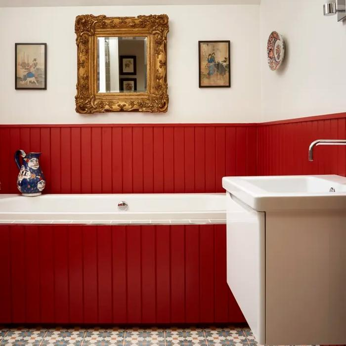 Red panelling and patterned floor tiles in a classic bathroom