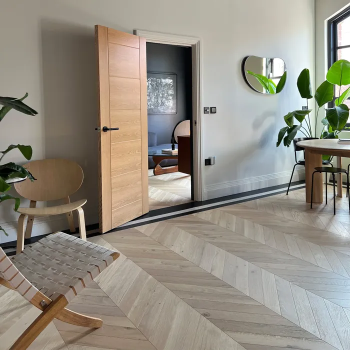 Modern interior with light chevron flooring