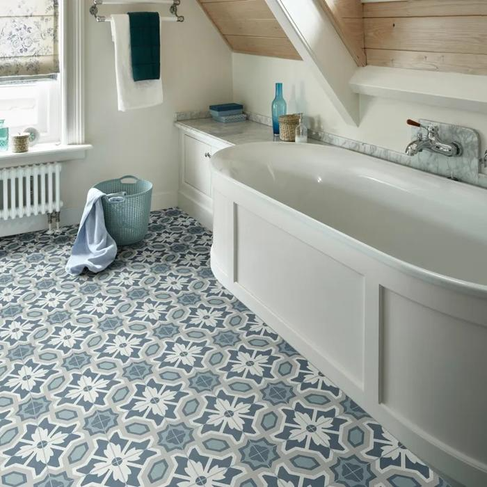 Freestanding tub on top of decorative floor tiles