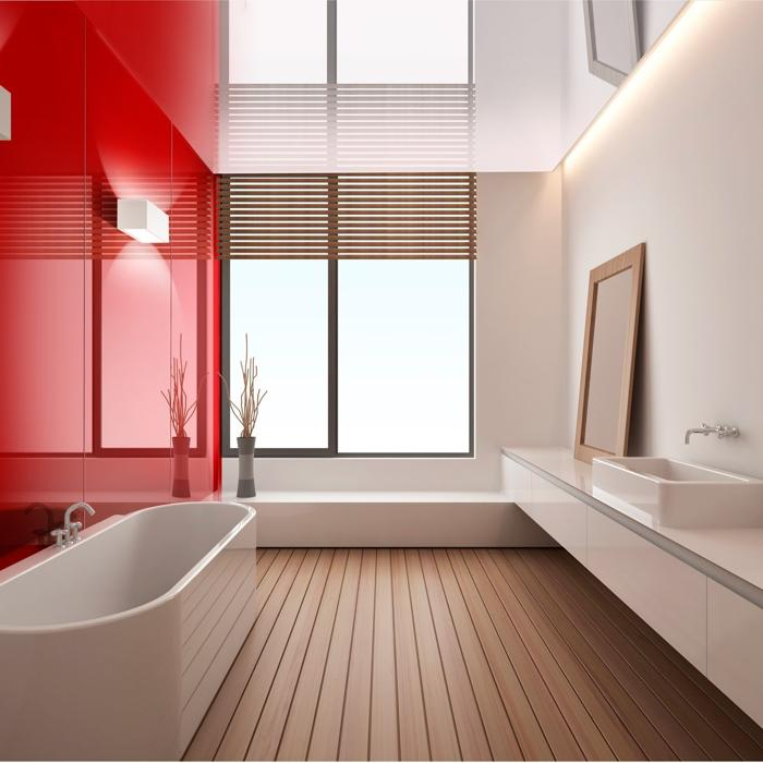 Modern bathroom with glossy red feature wall and wooden flooring