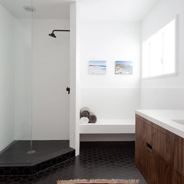 Contemporary walk-in shower with black hexagon tiles and white walls