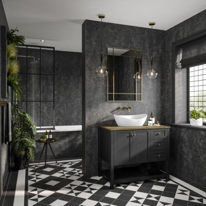 Dark stone effect wall panels in a bathroom with geometric floor tiles