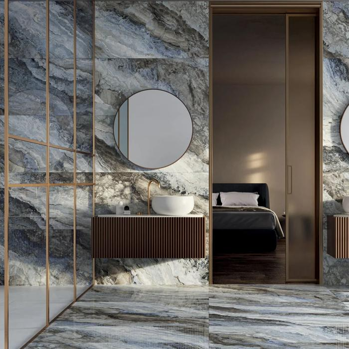 Luxurious bathroom with dark marble effect tiles and brass fixtures