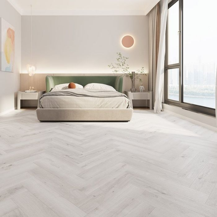 Modern bedroom with light herringbone flooring