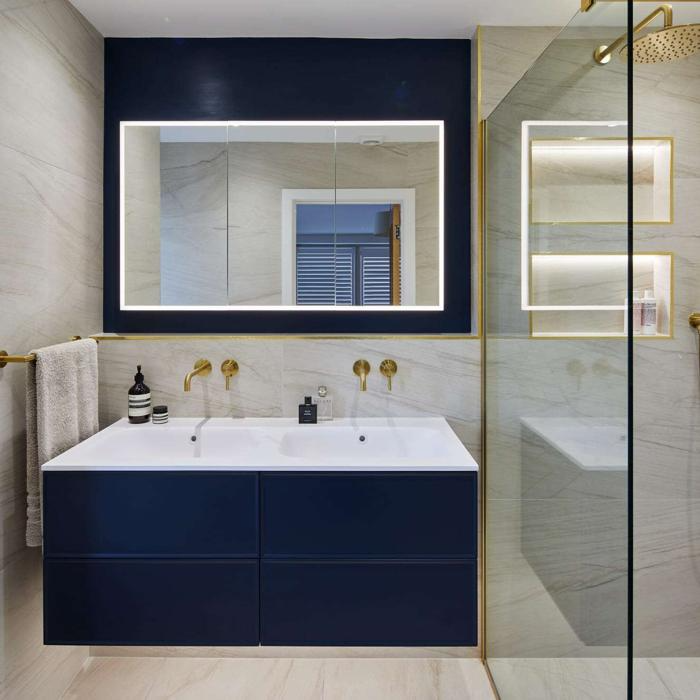 Navy blue tiles with marble effect walls in a modern bathroom