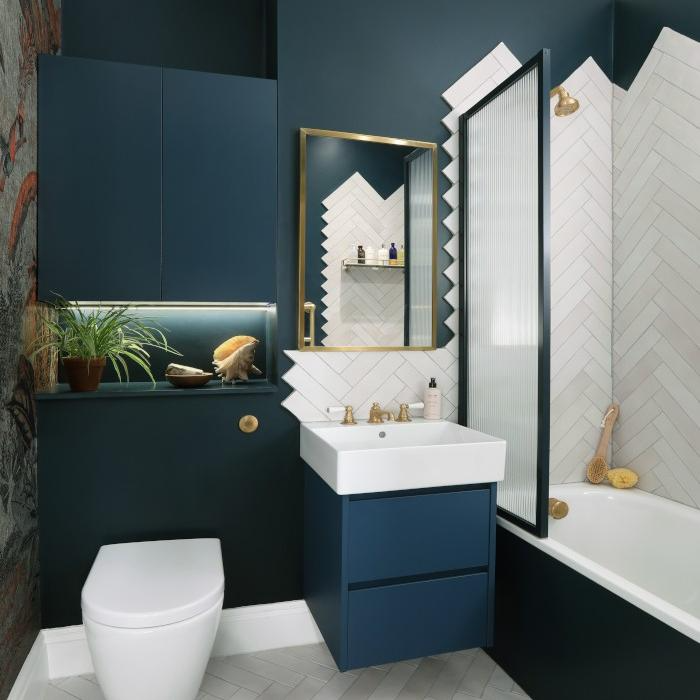 Blue green vanity and walls with white herringbone tiles