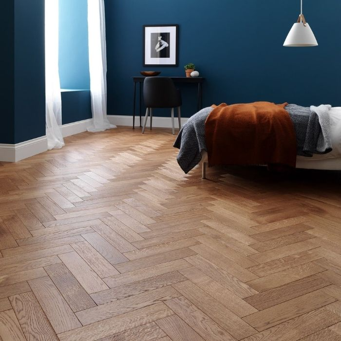 Bedroom with dark wood herringbone flooring