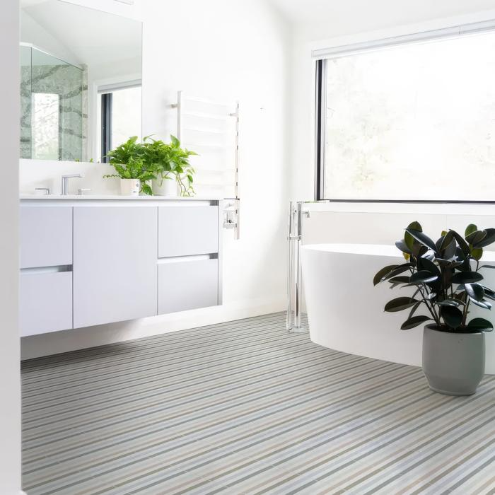 Striped floor tiles in bright bathroom