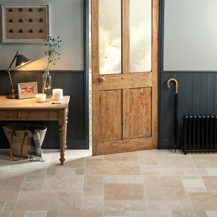 Entryway with table and travertine tiles beneath