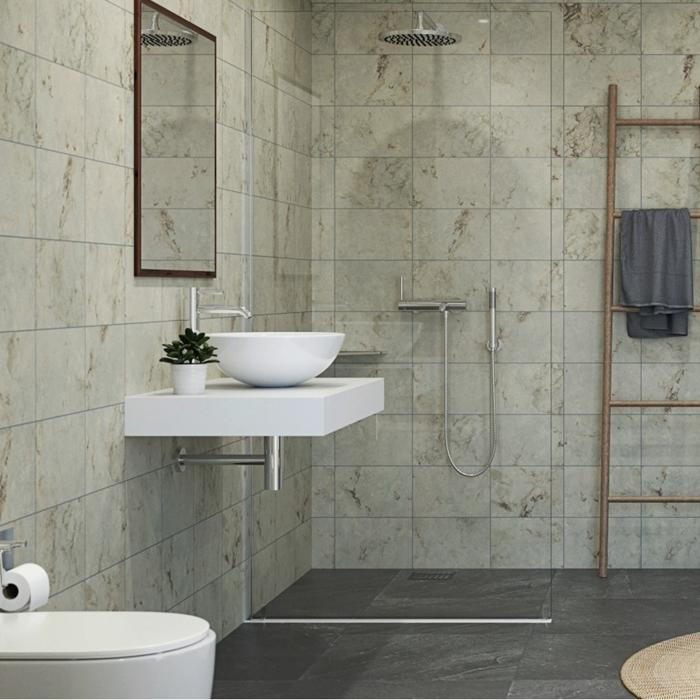 Beige stone tiles in a bathroom with a floating sink and wooden ladder