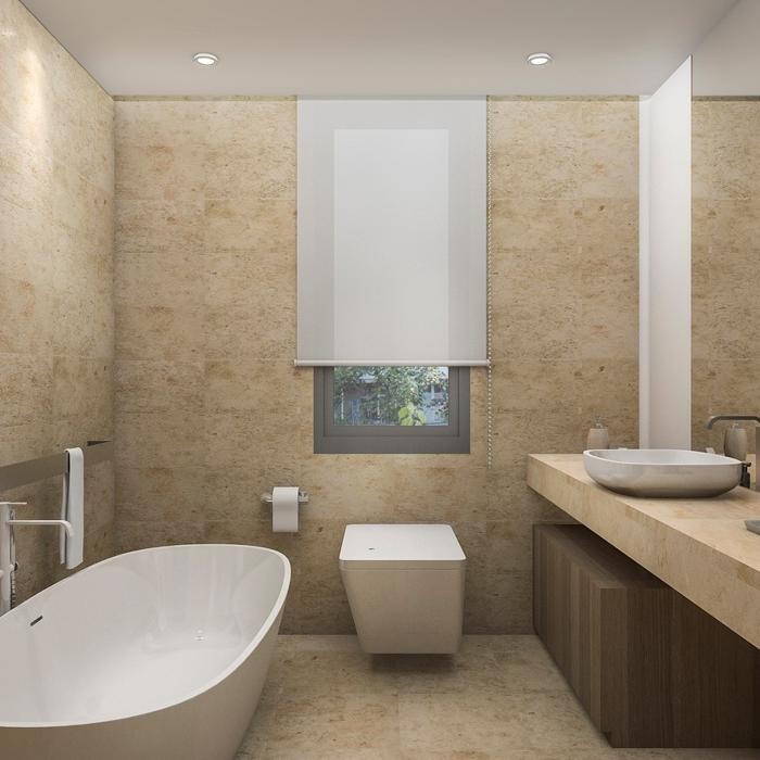 Beige stone wall panels in a bathroom with a freestanding tub