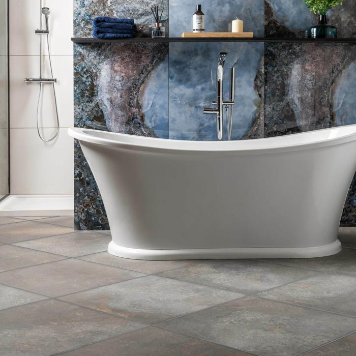 Freestanding bath with stone effect floor tiles