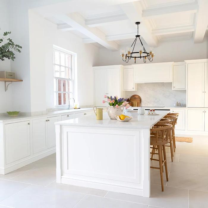 White cabinets and sandstone floor tiles in kitchen