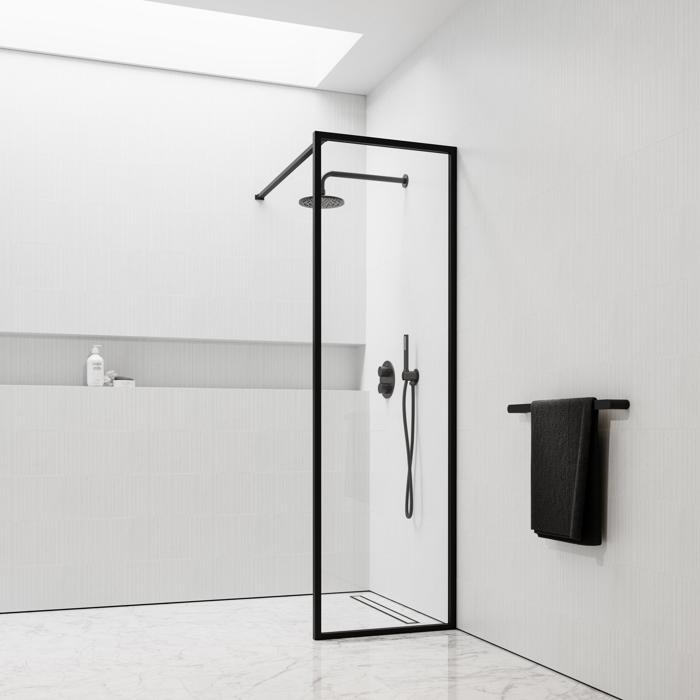 Shower screen with black trim and white tiles