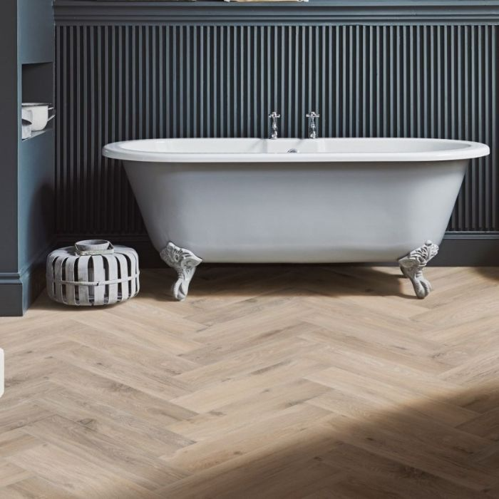 Bathroom with clawfoot tub and herringbone flooring